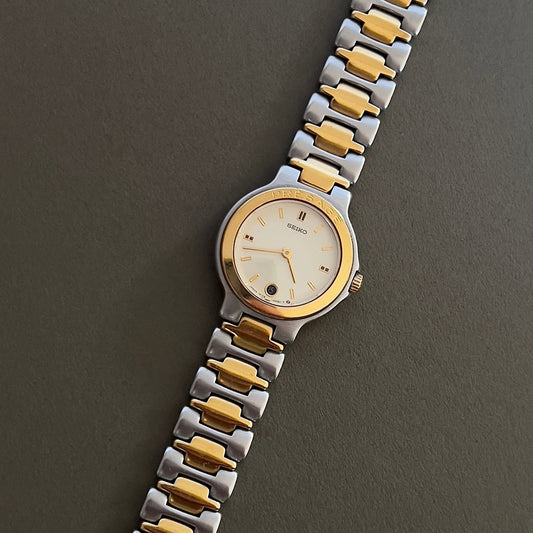 Seiko presage Two-tone silver and gold watch on a dark background