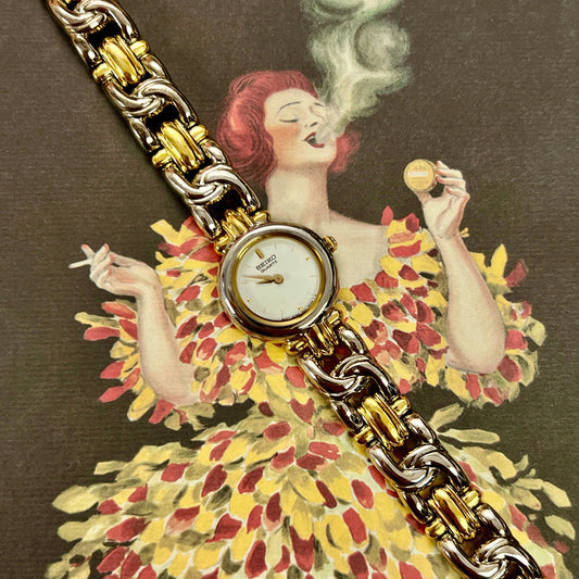 Vintage-style advertisement with a woman in a floral dress and gold watch, featuring the brand 'Achou Lajaunie'.