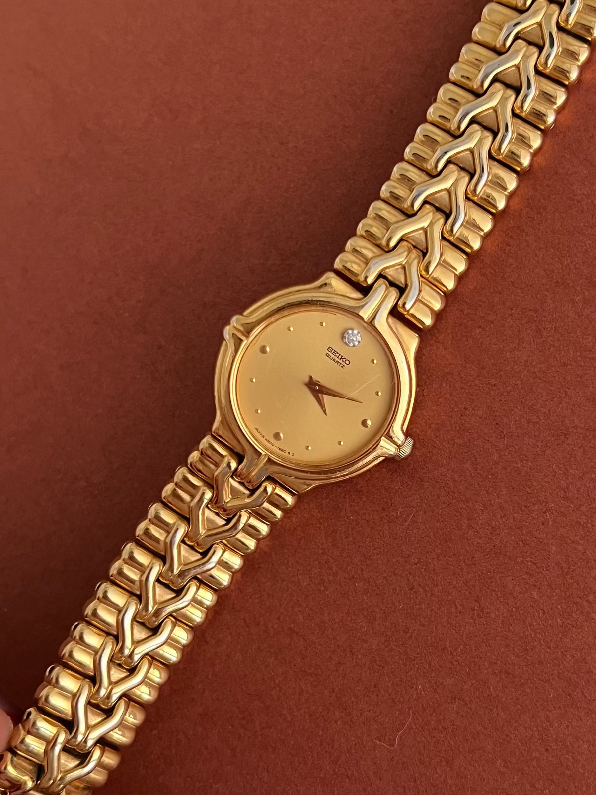 Seiko Woman's Watch Gold with Chevron Pattern Bracelet, front view of a vintage women's watch at Gilded Hour.