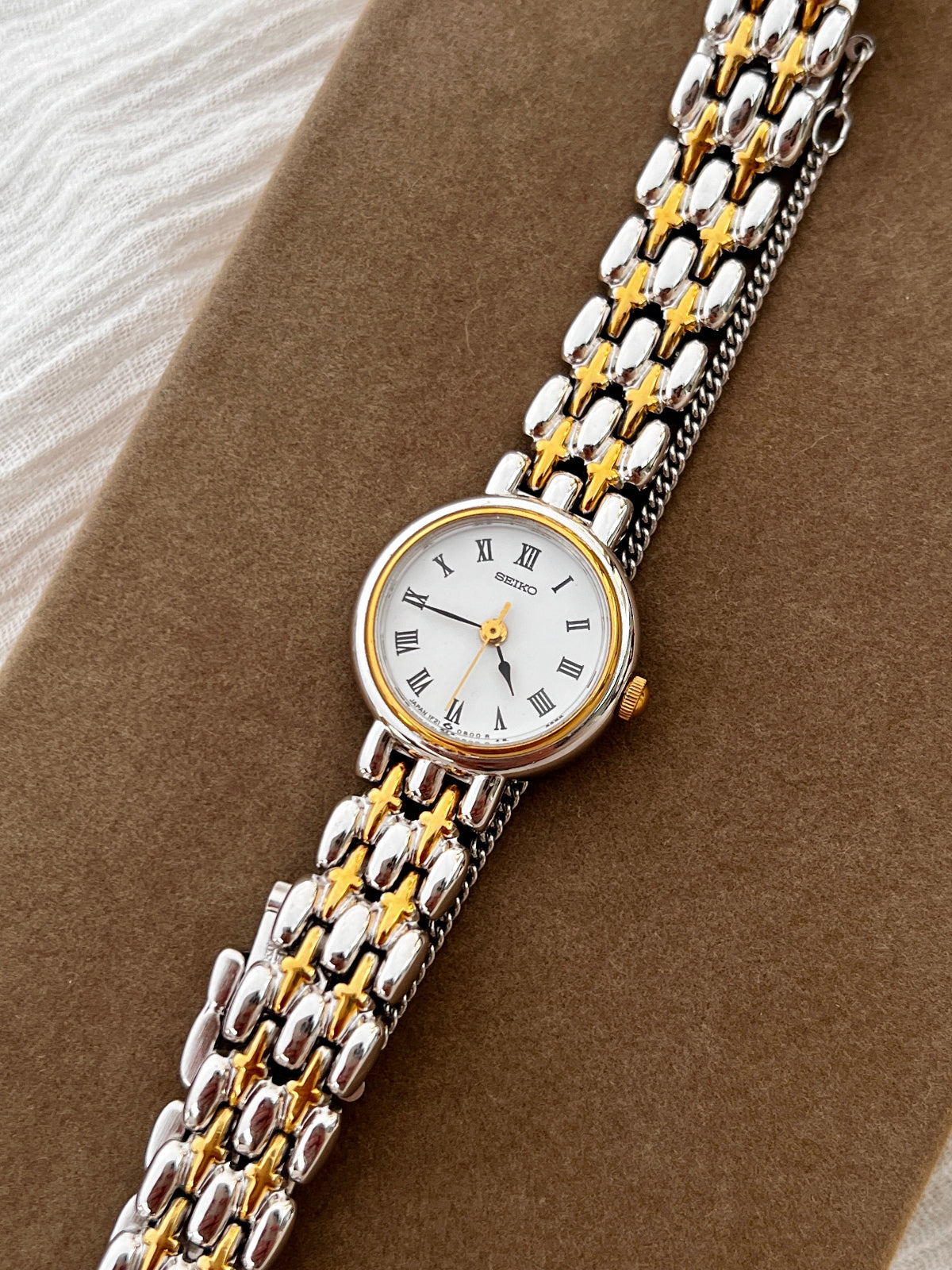 Seiko vintage ladies dress watch with two-tone gold and silver bracelet, white Roman numeral dial, and spade hands – classic quartz timepiece from Gilded Hour NZ.