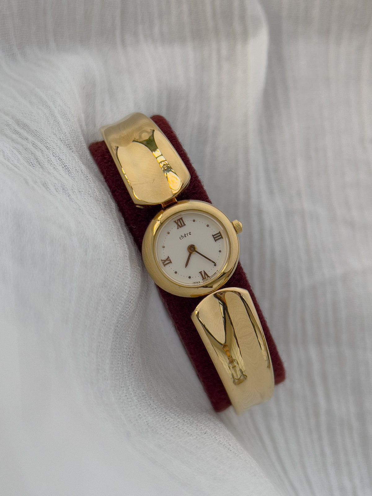 Vintage Citizen Chère women’s gold bangle watch with white dial and Roman numeral, styled on wrist with a crystal tennis bracelet
