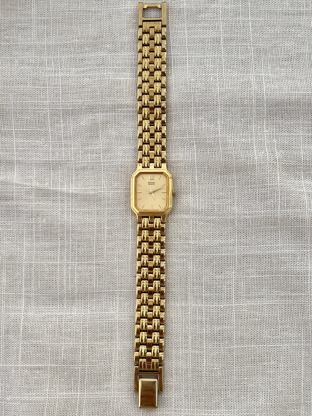 Vintage Seiko gold tank watch with rectangular case and cream dial