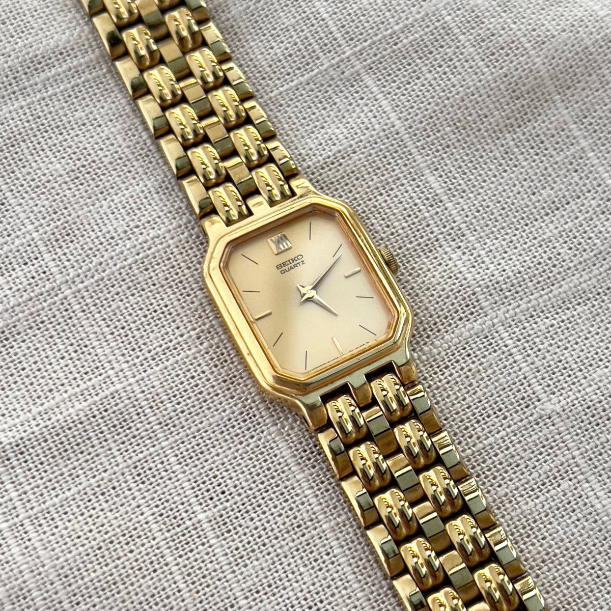 Vintage Seiko gold tank watch with rectangular case and cream dial