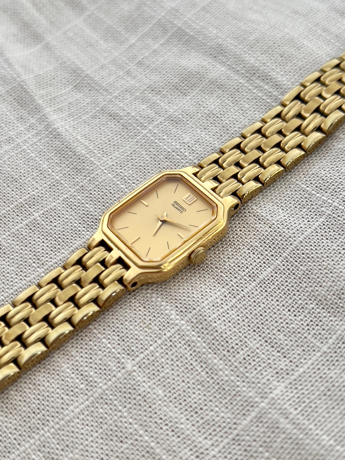 Vintage Seiko gold tank watch with rectangular case and cream dial