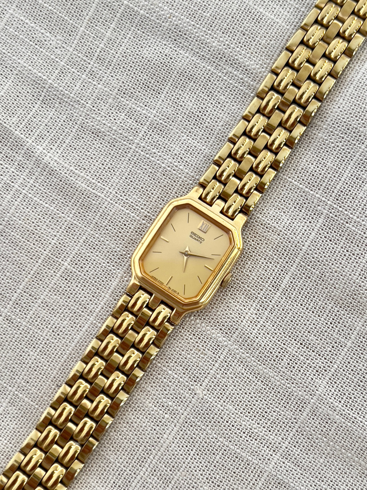 Vintage Seiko gold tank watch with rectangular case and cream dial