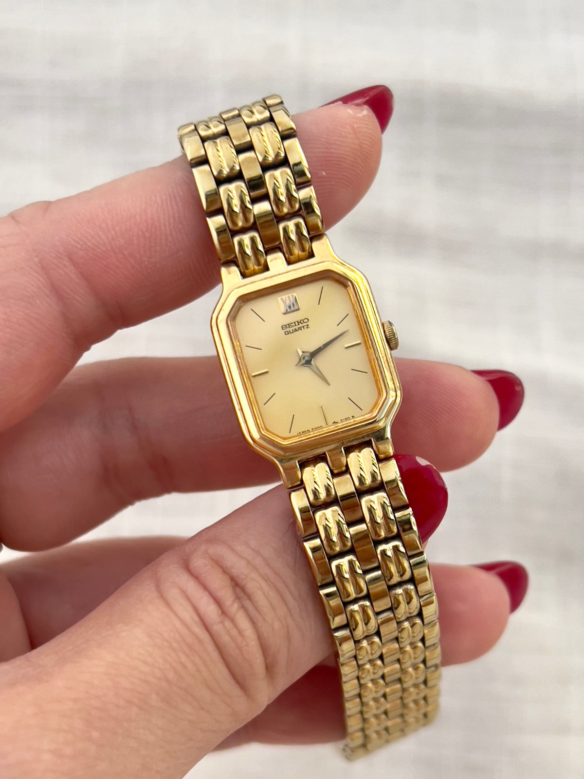 Vintage Seiko gold tank watch with rectangular case and cream dial