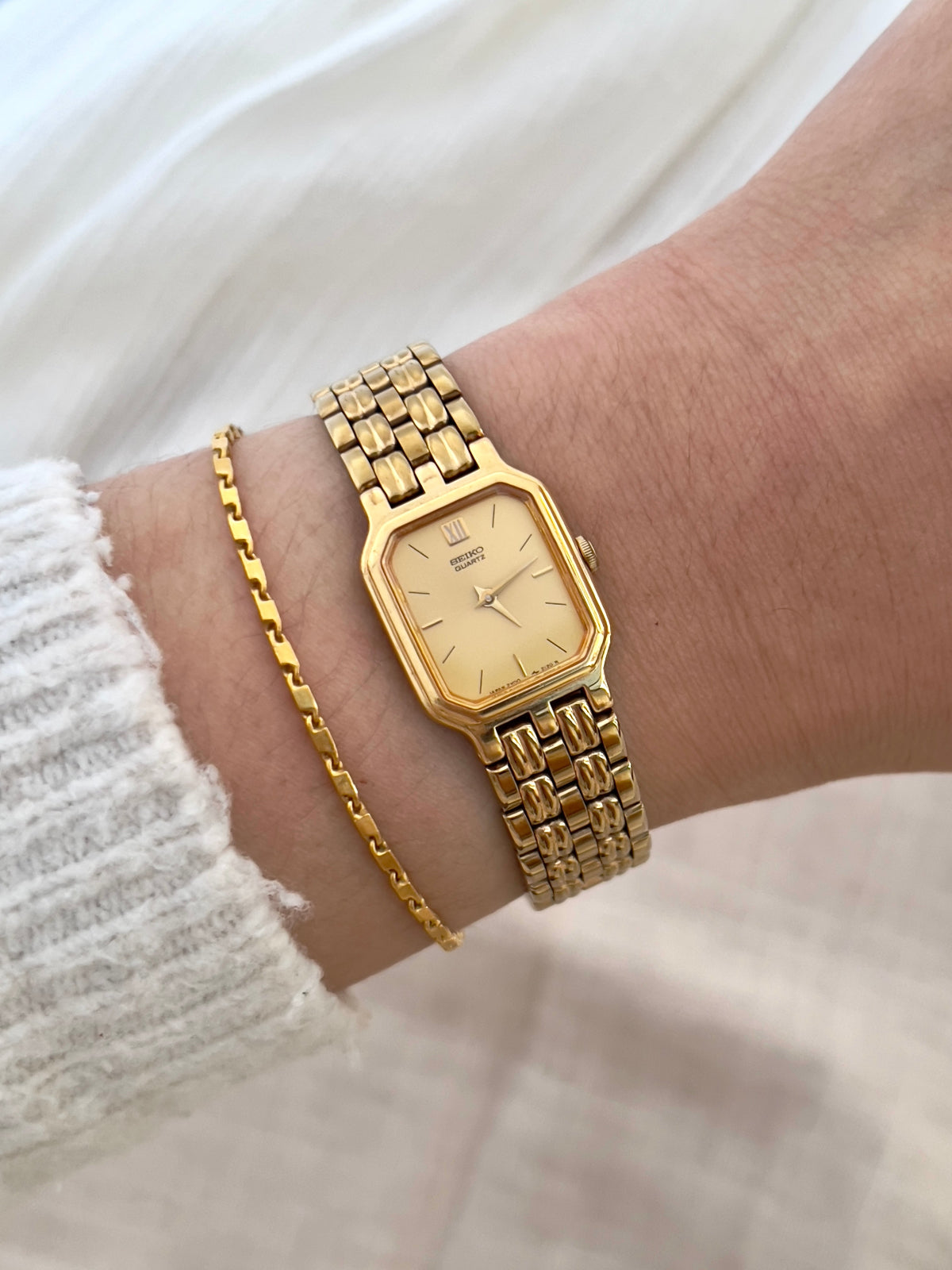 Vintage Seiko gold tank watch with rectangular case and cream dial