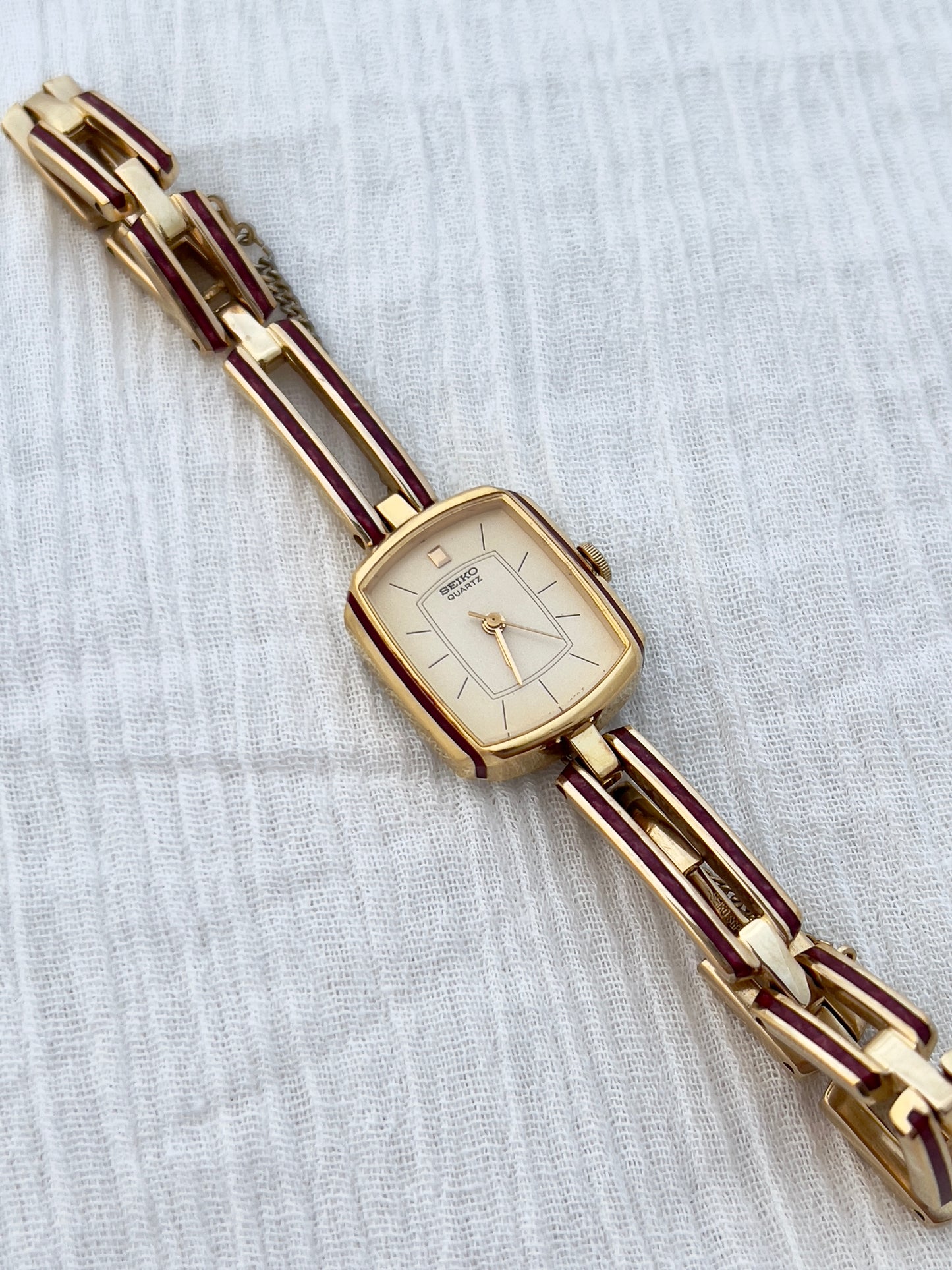 Seiko Ladies Gold Bracelet Watch with Crimson Enamel Accents