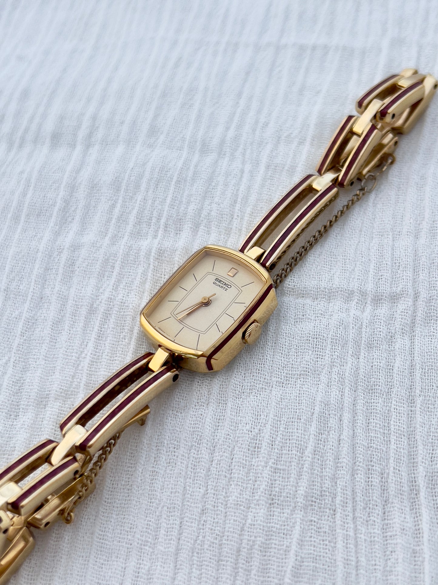 Seiko Ladies Gold Bracelet Watch with Crimson Enamel Accents