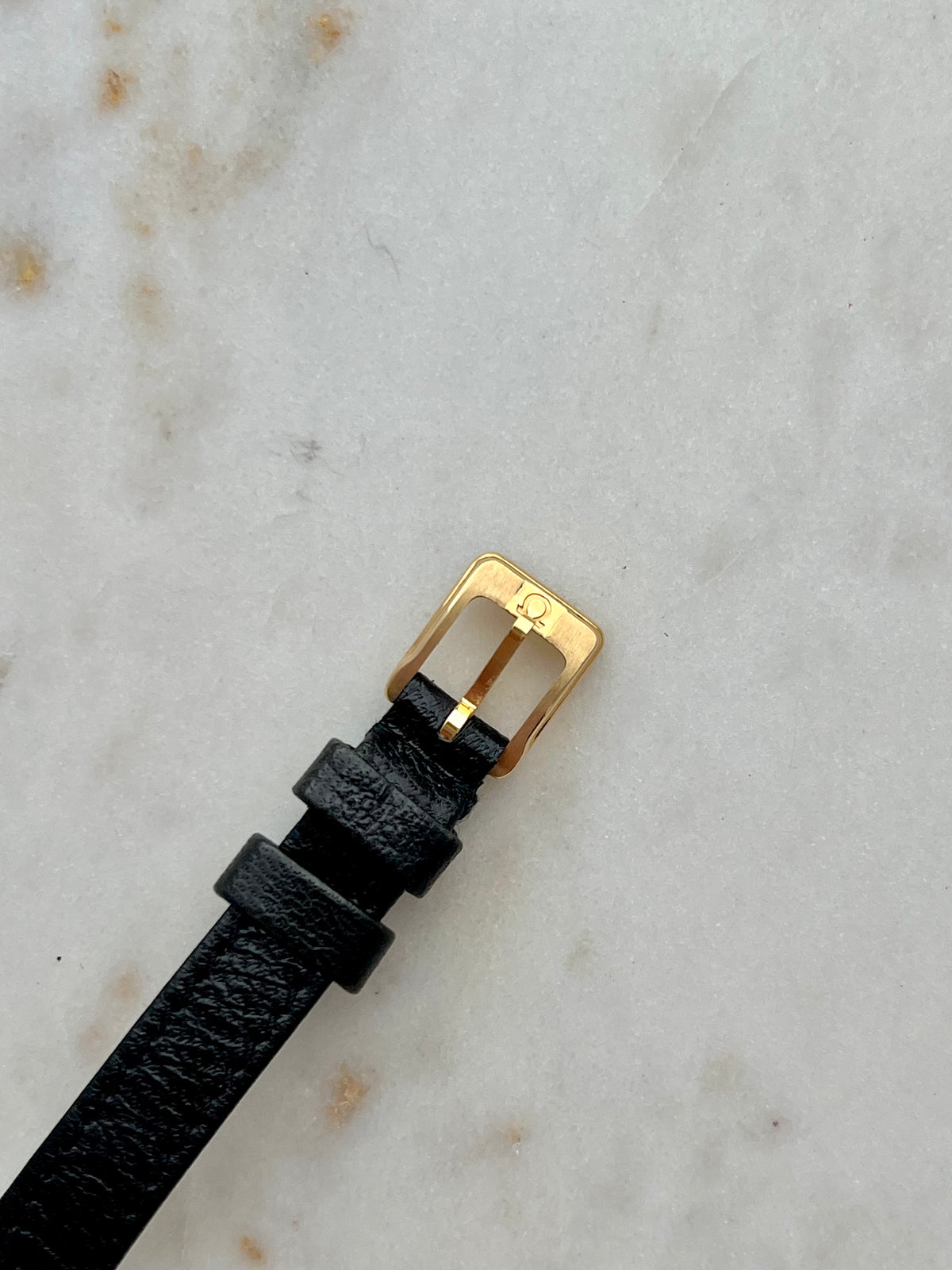 Omega De Ville Wreath Dial Two Tone Strap Watch: signed gold tone buckle close up.