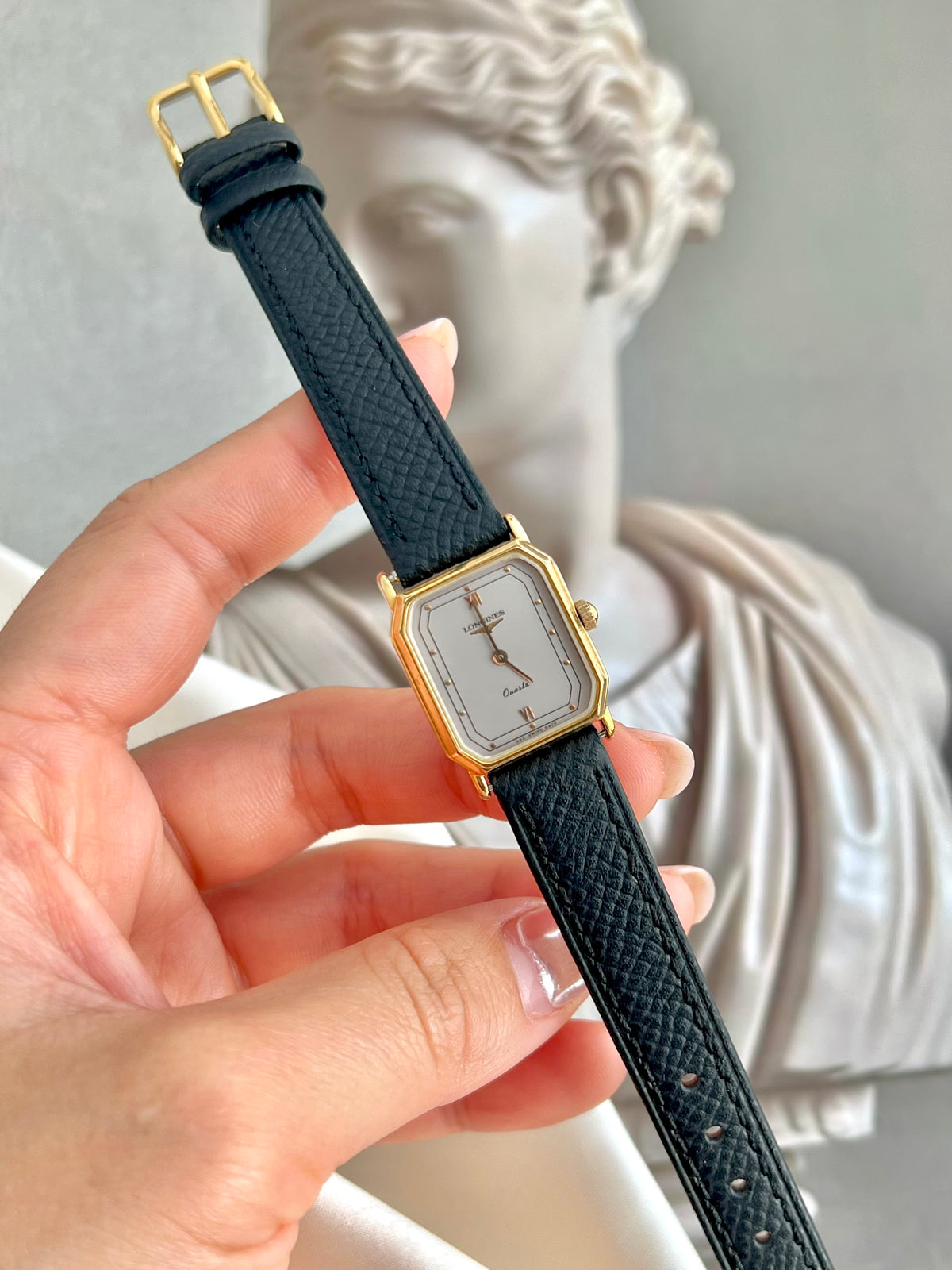 Longines Gold Tone Rectangular Women's Watch with a Smoke Silver Dial, dial close up of a vintage women's watch at Gilded Hour.
