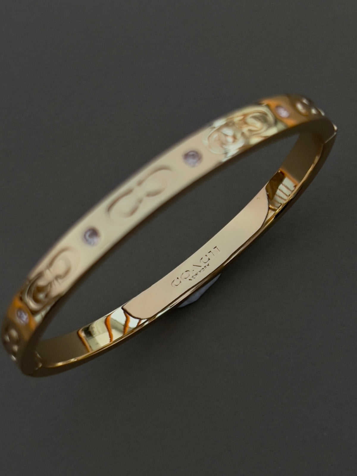 Coach Gold Toned Hinged Bangle with in-laid Crystals, dial close up of a vintage women's watch at Gilded Hour.