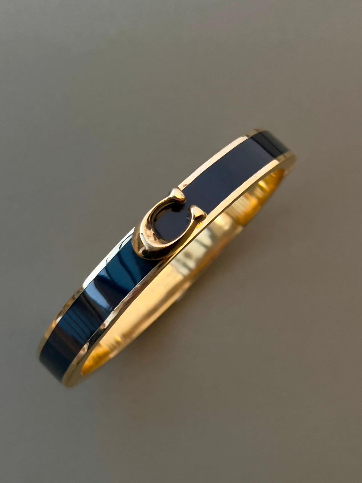 Coach Black Bangle with a "C" Logo, angled view of a vintage women's watch at Gilded Hour.