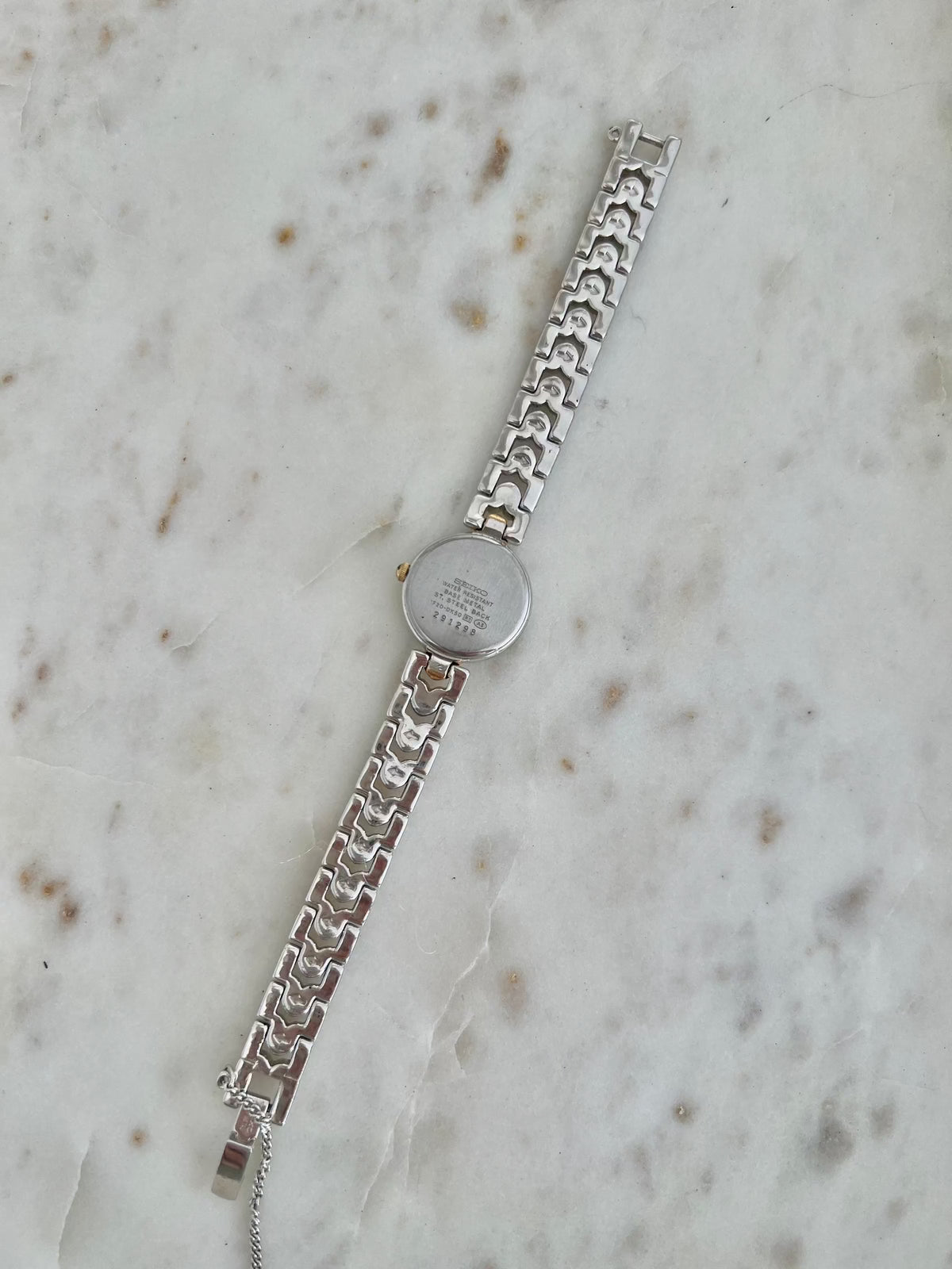Seiko Tisse Blue Dial Heart Link Watch: 1F20-0K50 case back and full bracelet underside.