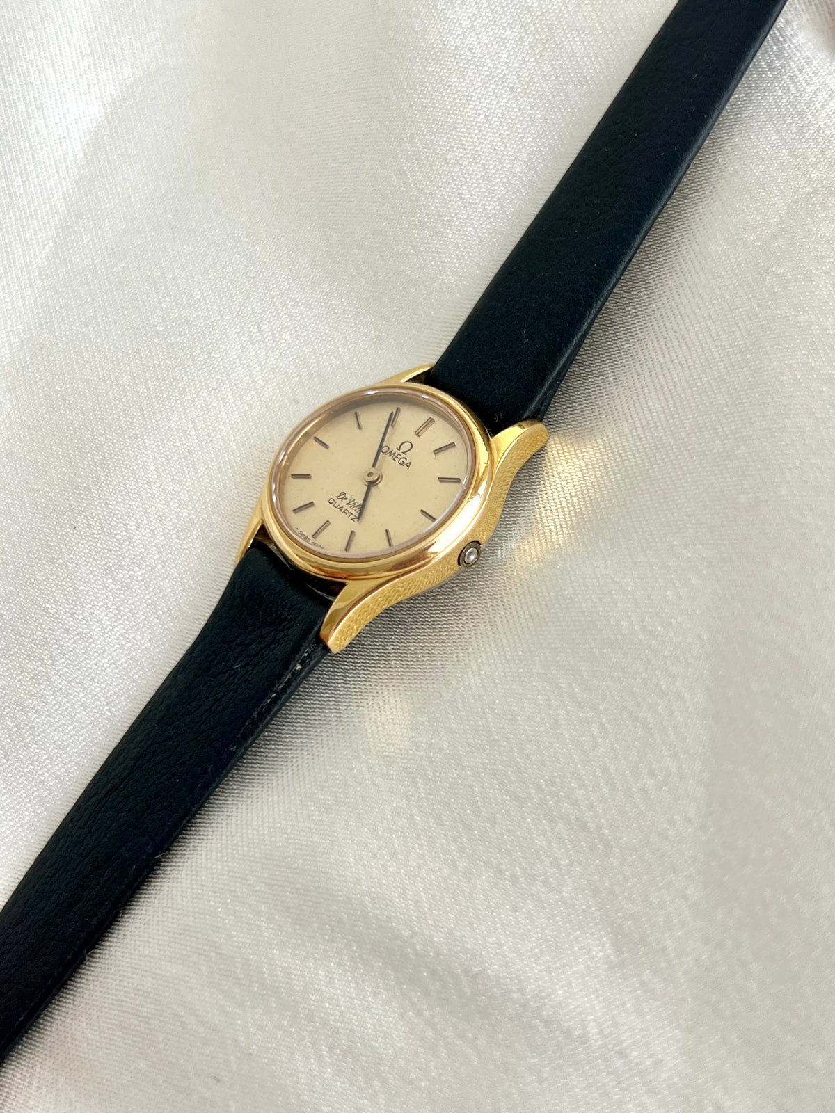 Omega De Ville Oval Gold Tone Strap Watch, caseback detail of a vintage women's watch at Gilded Hour.