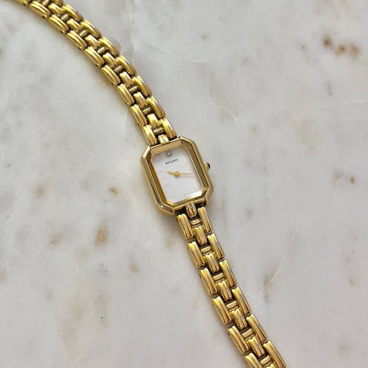 Gold watch on a marble surface