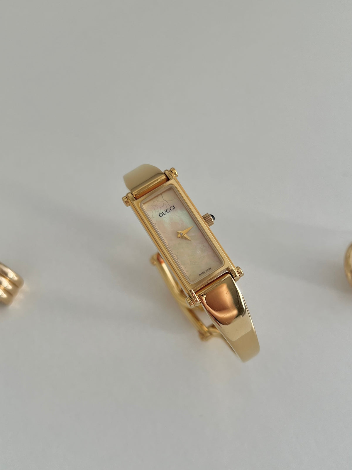 Gucci 1500 Gold Bangle Women’s Watch Mother of Pearl Dial, caseback detail of a vintage women's watch at Gilded Hour.