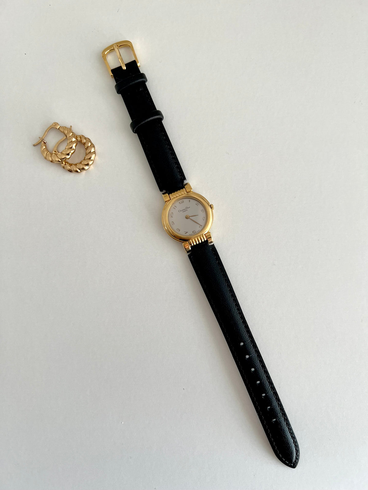 Christian Dior Gold Dress Watch with Black Strap, angled view of a vintage women's watch at Gilded Hour.