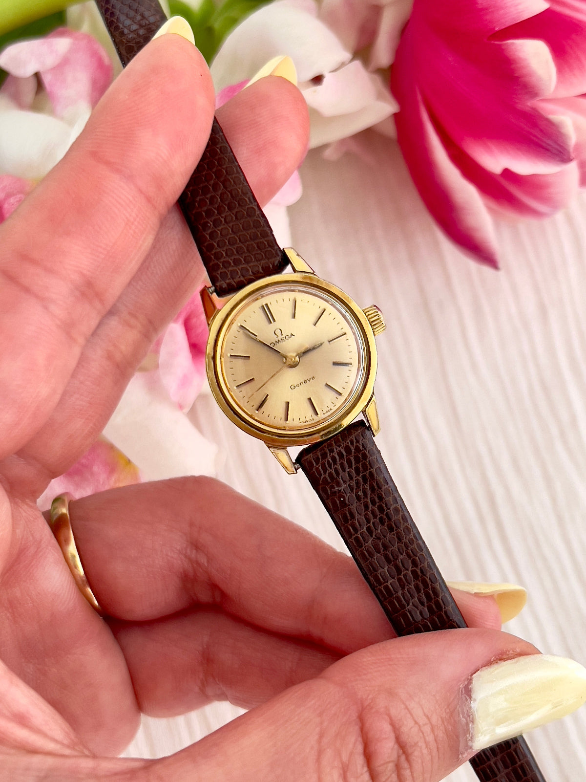 Vintage Omega Genève ladies gold watch with champagne dial and brown textured leather strap, Swiss dress timepiece for women in New Zealand.