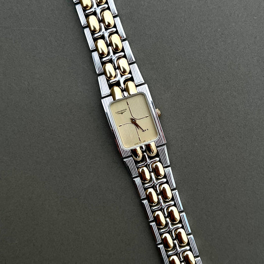 Longines QWR ladies two tone gold and silver bracelet watch with champagne guilloche dial on dark background