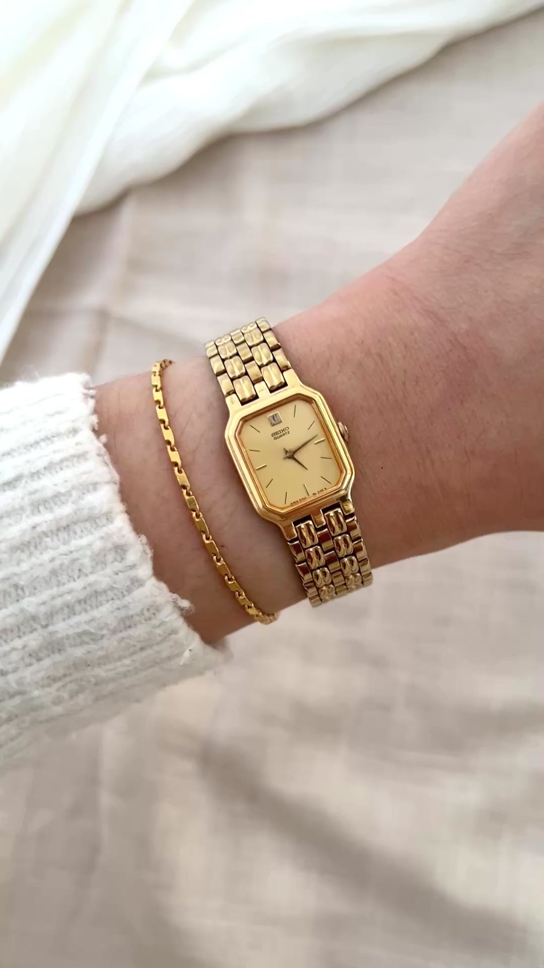 Vintage Seiko gold tank watch with rectangular case and cream dial