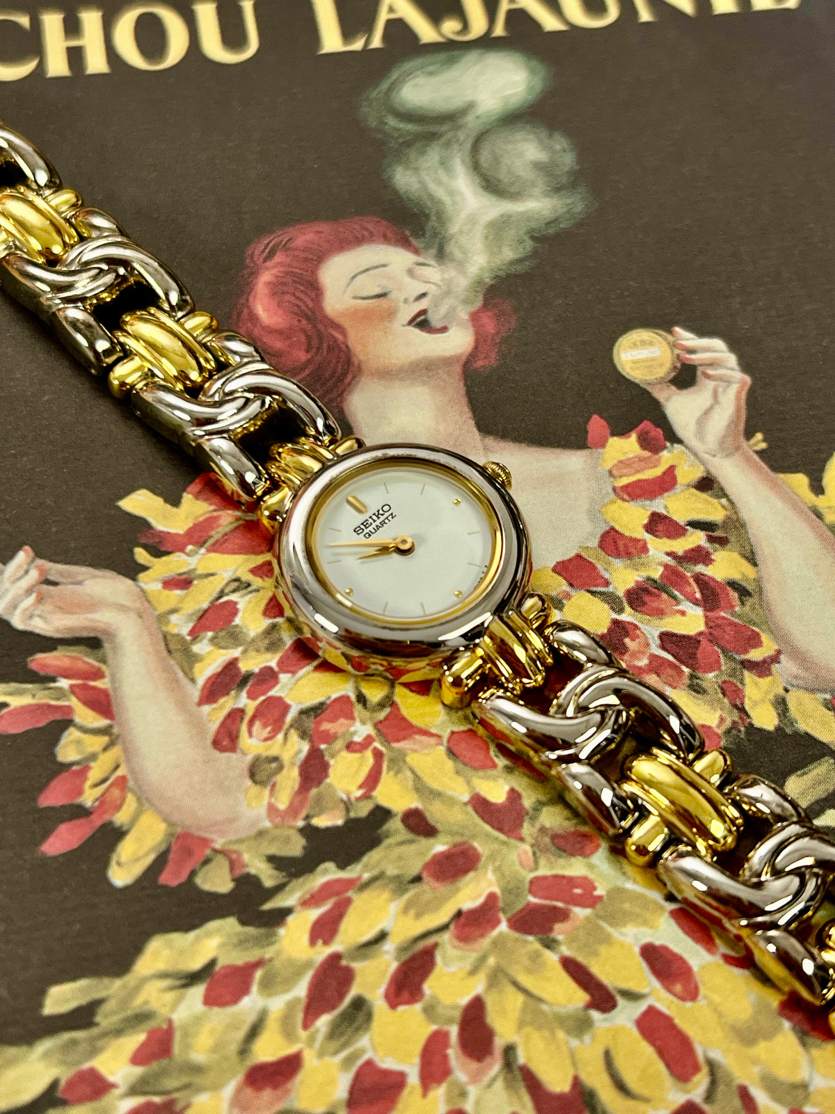 Seiko petite two-tone bracelet watch with white textured dial and gold accents.