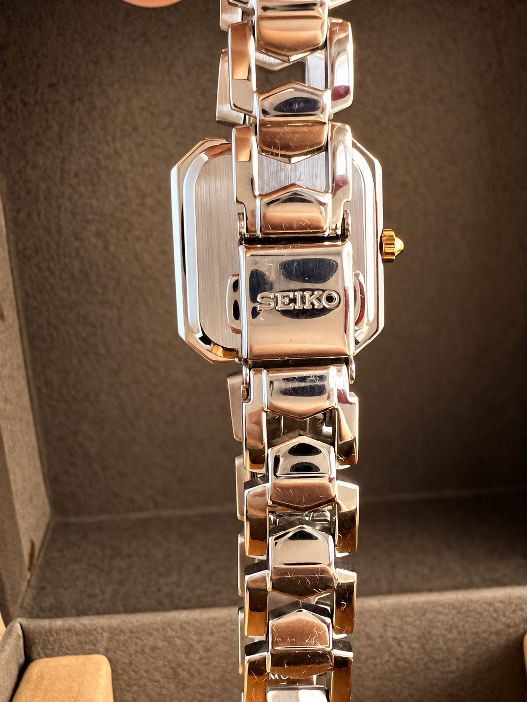 Rear view of the Seiko silver open link bracelet and signed folding clasp resting over the caseback