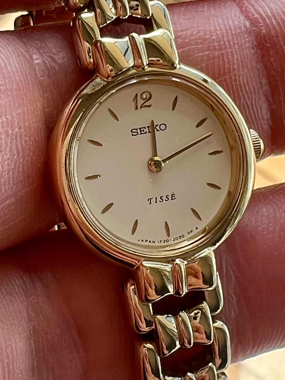 Seiko Tissé 1F20 1B00 women’s watch with a pearl champagne dial, sculpted 12 marker and geometric gold tone bracelet