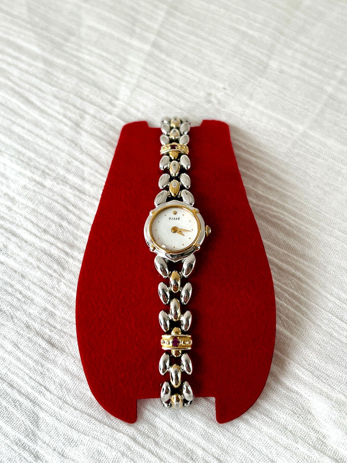 Seiko Tisse Mother of Pearl Women’s Watch with Ruby Bracelet Accents — front view of dial and two tone bracelet.