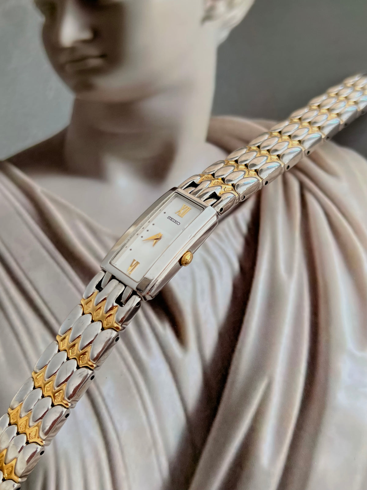 Seiko two-tone women's watch with sculpted bracelet links.