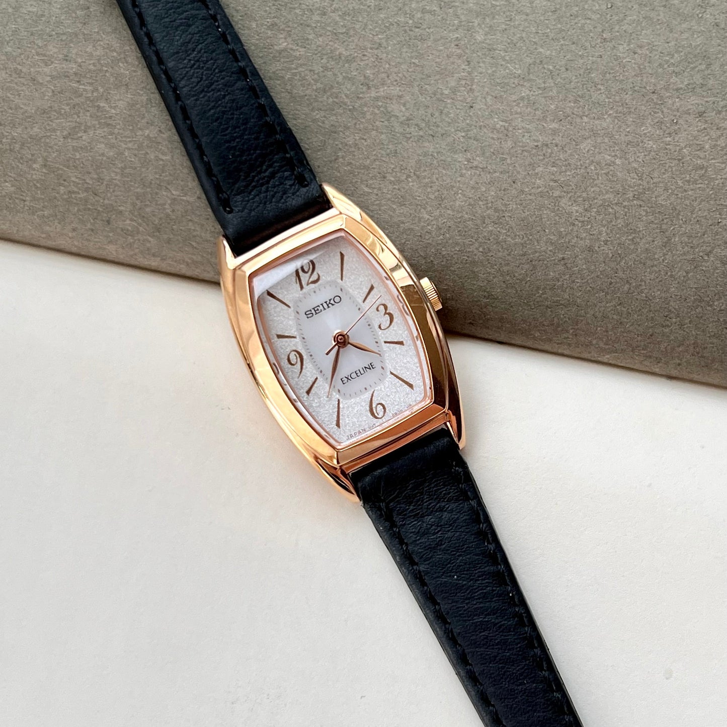 Seiko Exceline ladies gold tonneau watch with stardust dial and black leather strap