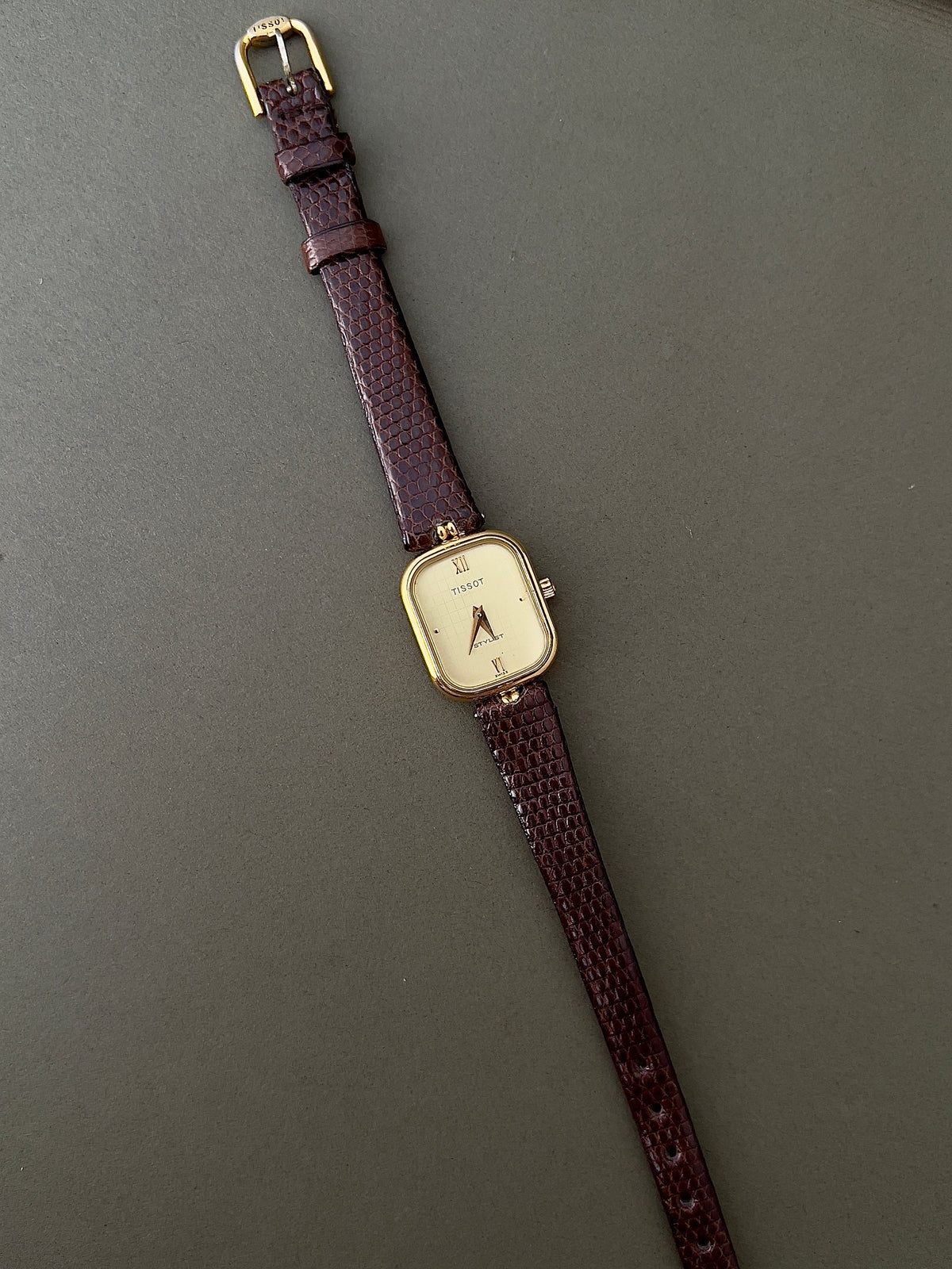 Tissot Stylist Gold Cushion Women’s Watch with Patterned Dial — full watch and brown strap.