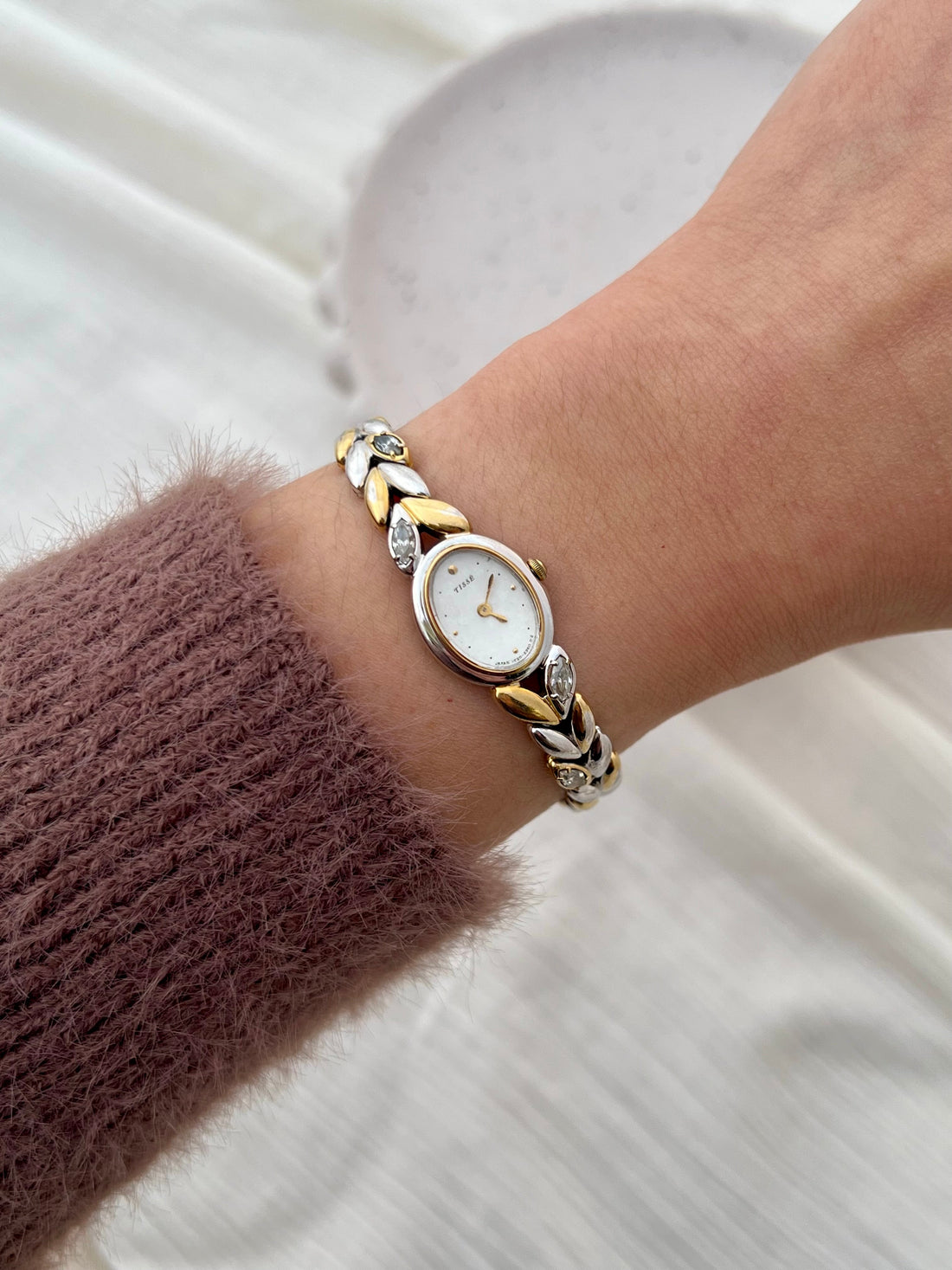 Two-tone Seiko Tissé jewellery watch with sculpted bracelet worn on the wrist
