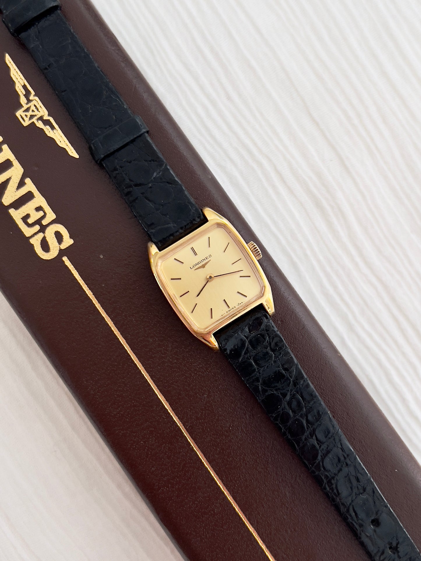Longines Gold Tonneau Ladies Watch with Golden Dial and Black Leather Strap