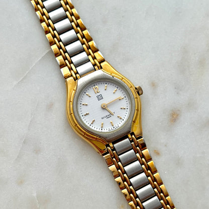 Two-tone Givenchy gold and silver watch on a marble surface