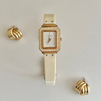 Golden Enamel Seiko Women's watch with a plain background