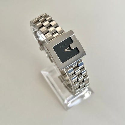 Silver Gucci 3600L watch with a square face on a light gray background
