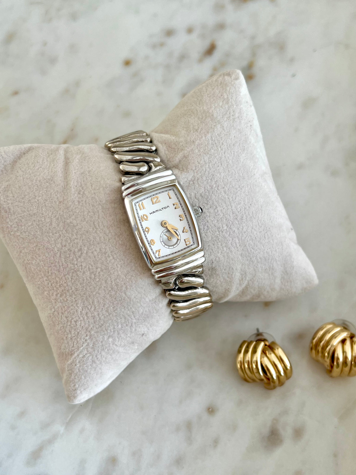 Hamilton Benton Silver Sculpted Watch: arabic dial and sculpted bracelet on cushion.