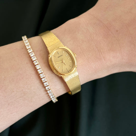Seiko 7321-6100 champagne dial and textured gold-tone watch worn on the wrist
