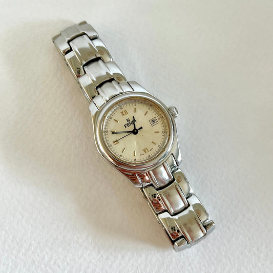 Silver Fendi women's watch with a white face on a light gray background
