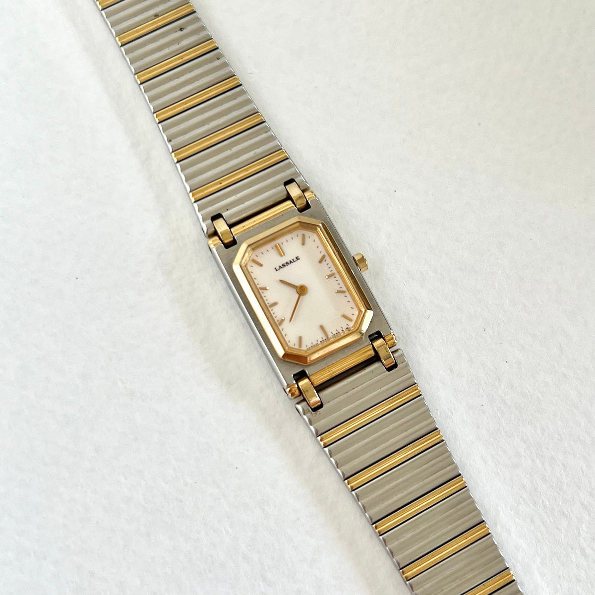 Lassale Wristwatch with gold and silver band on a white background