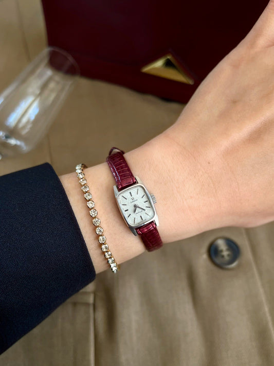 Omega De Ville Silver Linen Dial Burgundy Strap Women’s Watch worn on the wrist
