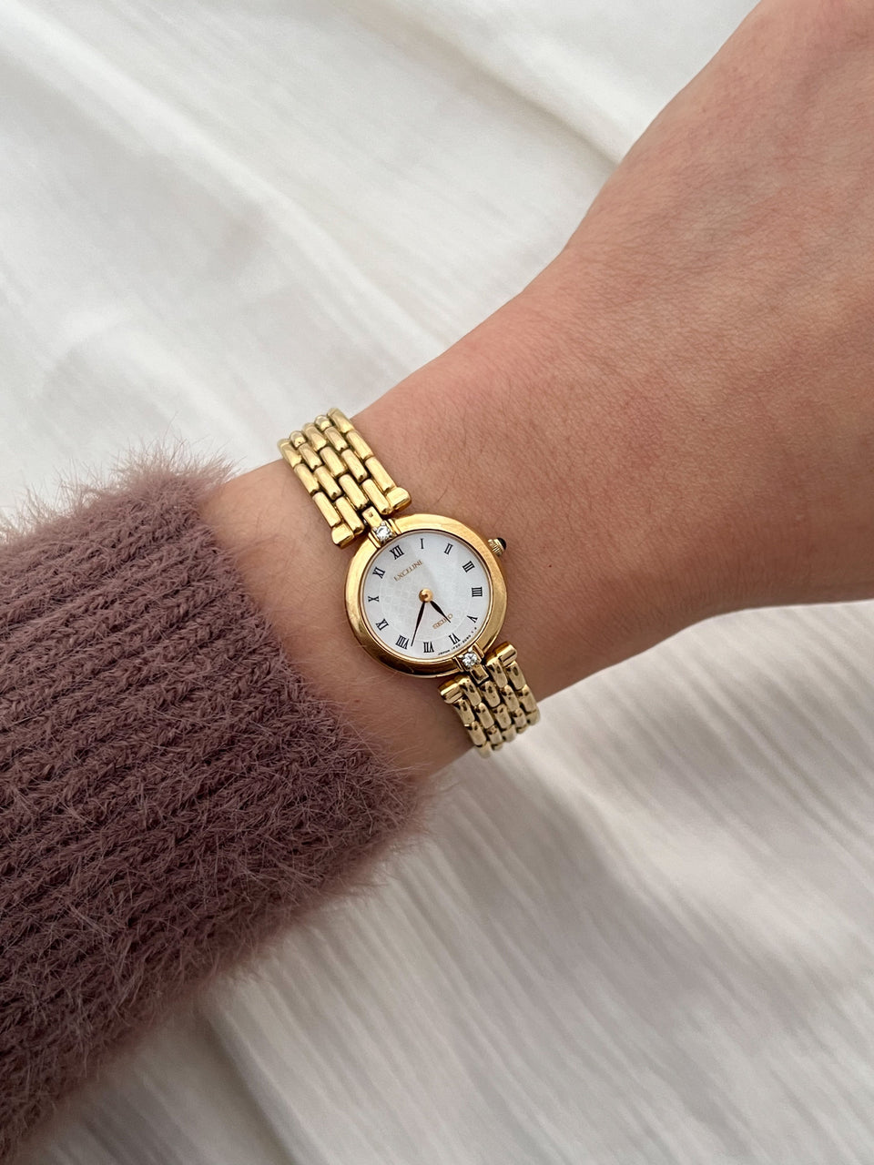 Seiko Exceline gold-tone bracelet watch with diamond accents worn on the wrist