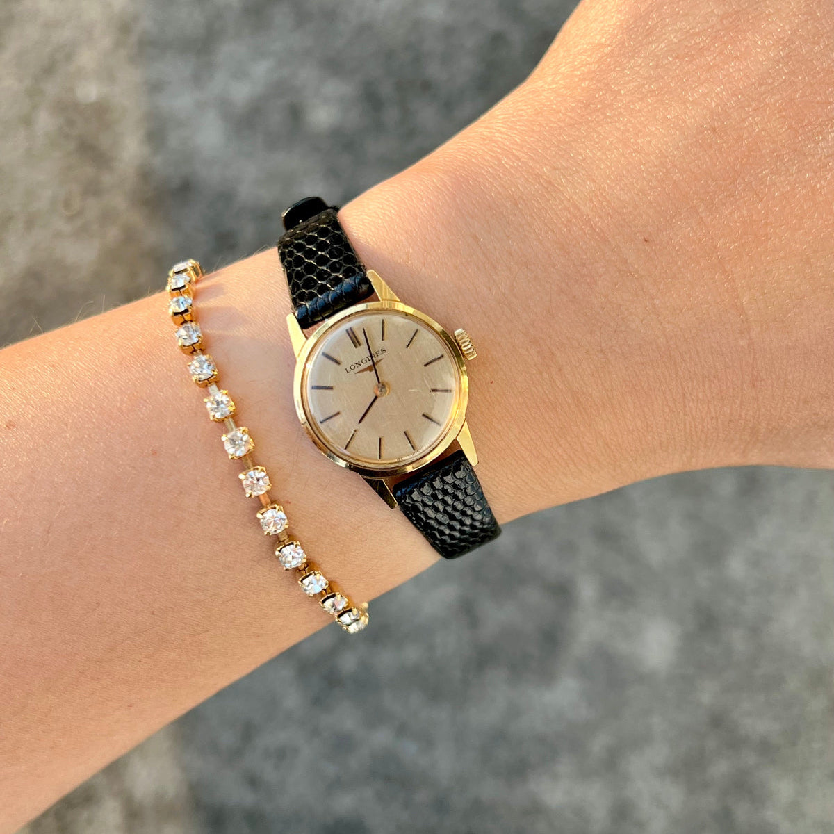 Longines Women's Watch NZ gold plated round case and domed dial. Mechanical movement on a wrist coupled with a tennis bracelet