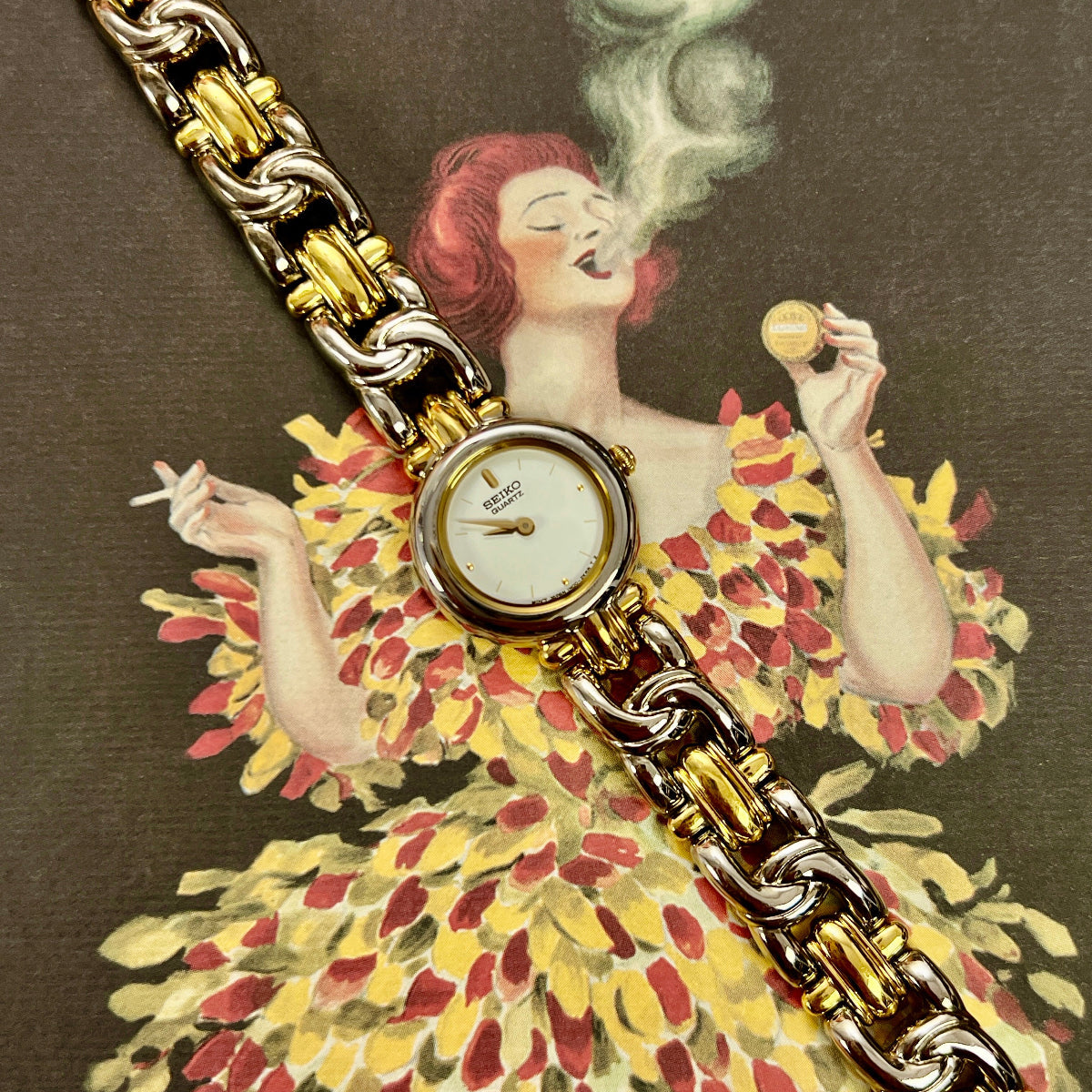 Vintage-style advertisement with a woman in a floral dress and gold watch, featuring the brand 'Achou Lajaunie'.