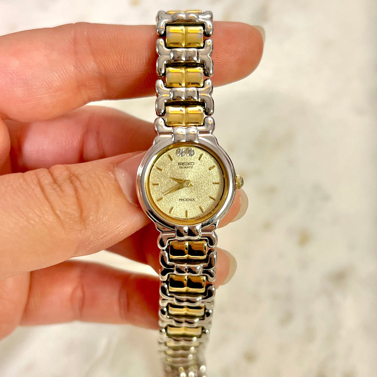 Seiko Women's Watch Vintage watch held by a hand against a blurred background