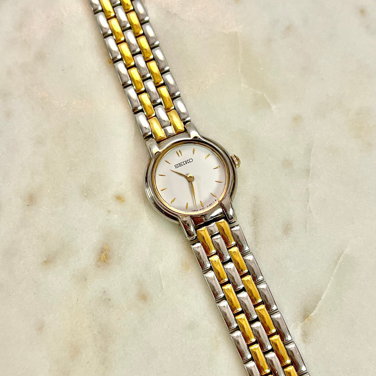Two-tone Seiko women's watch on a marble surface