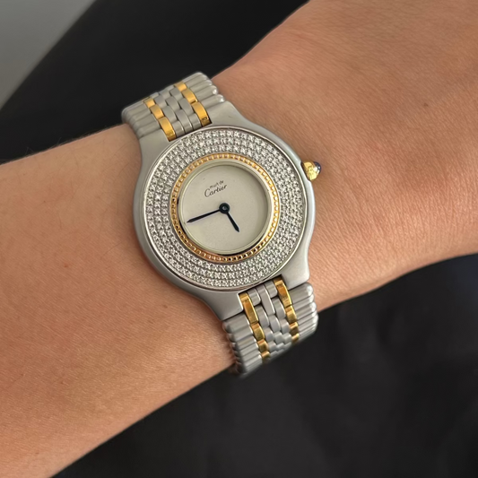 Must de Cartier 21 Silver and gold watch with diamond-studded band on wrist