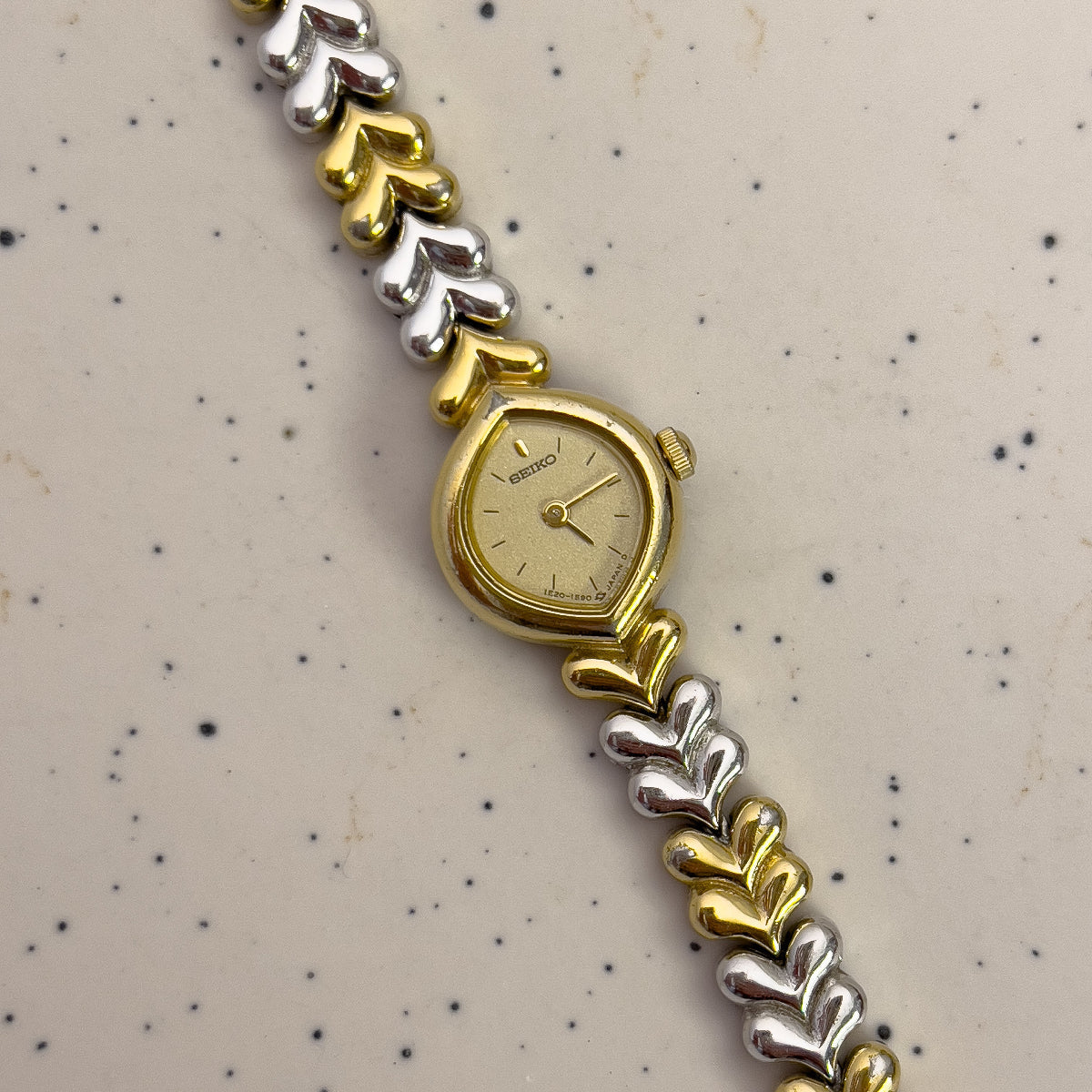 Seiko Gold and silver watch with a patterned background