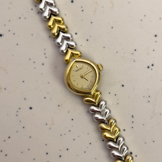 Seiko Gold and silver watch with a patterned background